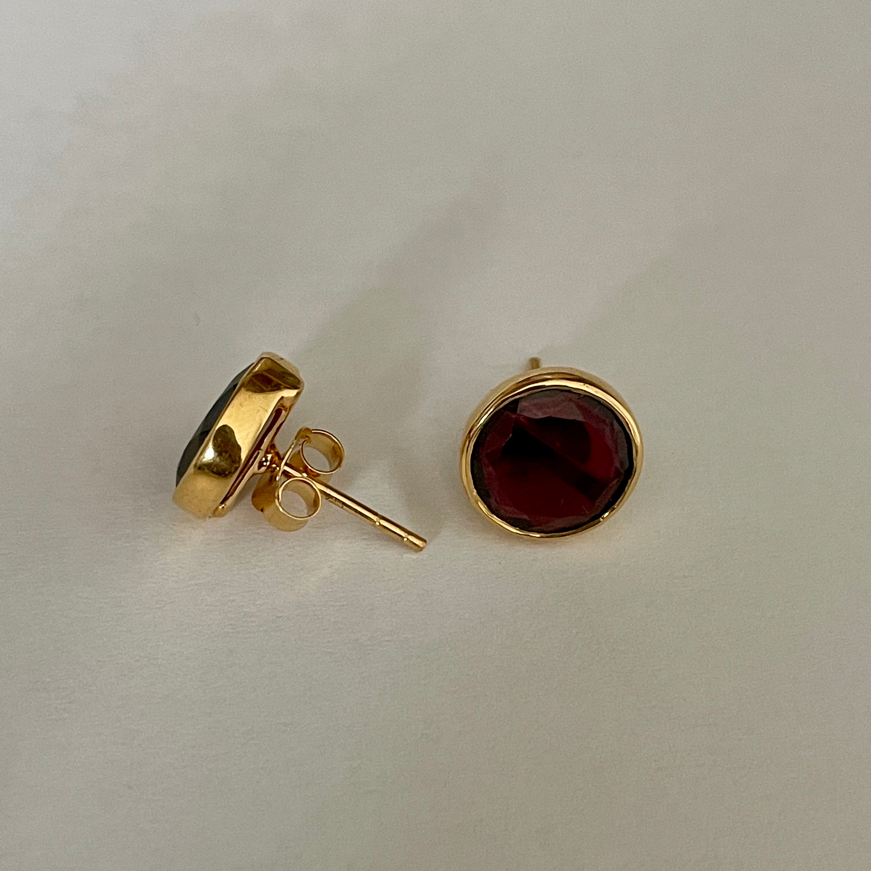 Garnet Studs in Gold Plated Sterling Silver with a Round Faceted Gemstone - Milina London