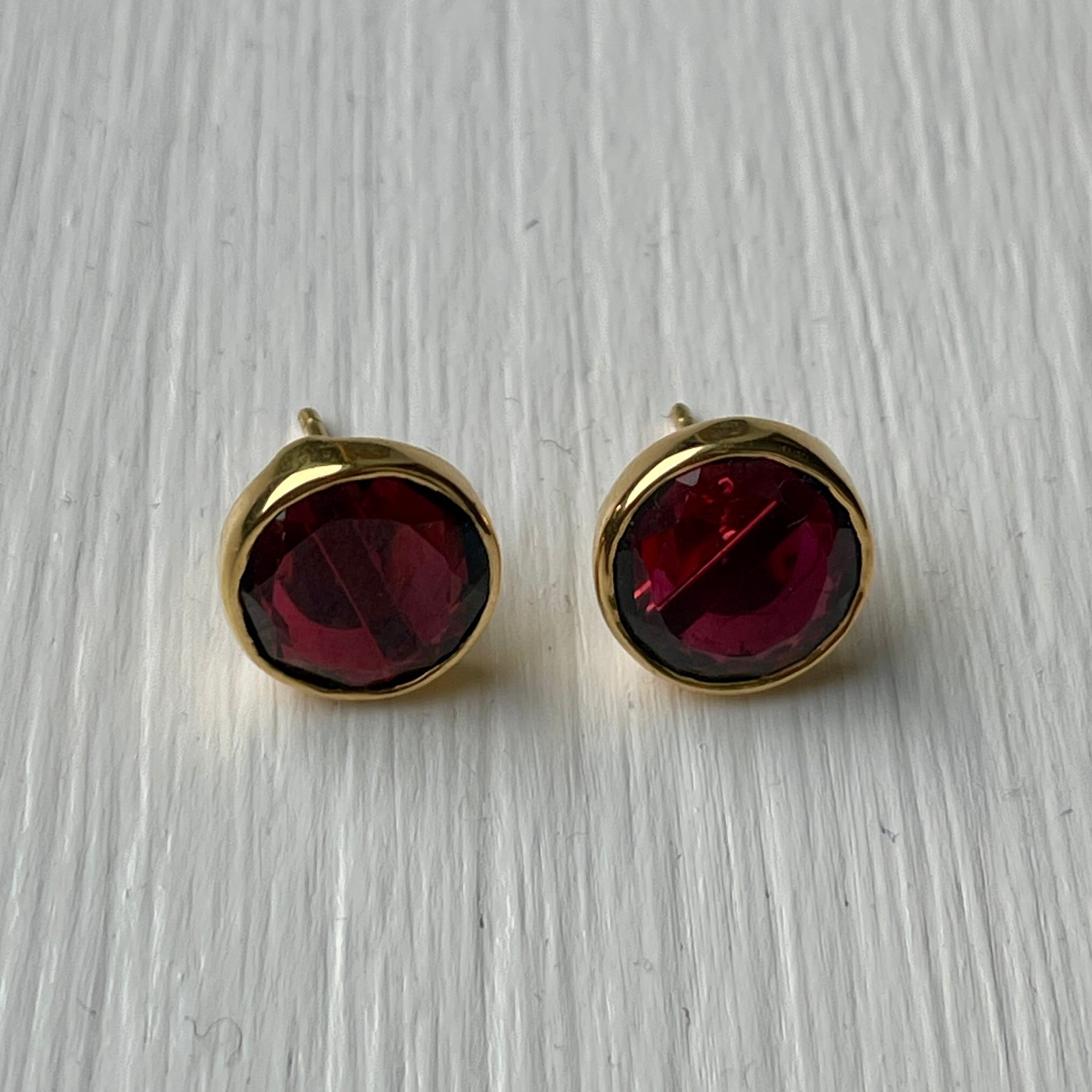 Garnet Studs in Gold Plated Sterling Silver with a Round Faceted Gemstone - Milina London